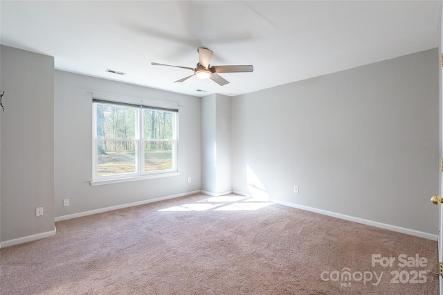 carpeted spare room with ceiling fan