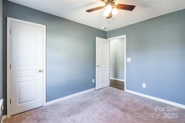 unfurnished bedroom with ceiling fan and light colored carpet