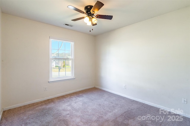 carpeted spare room featuring ceiling fan