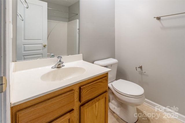 bathroom featuring tile patterned floors, vanity, and toilet