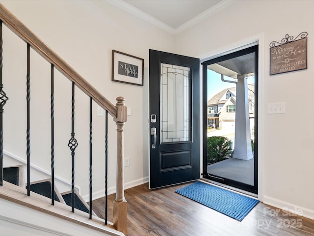 foyer entrance with wood-type flooring and ornamental molding