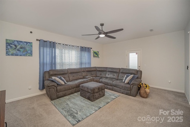 living room with ceiling fan, a wealth of natural light, and light colored carpet