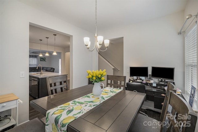 dining space with sink and a chandelier