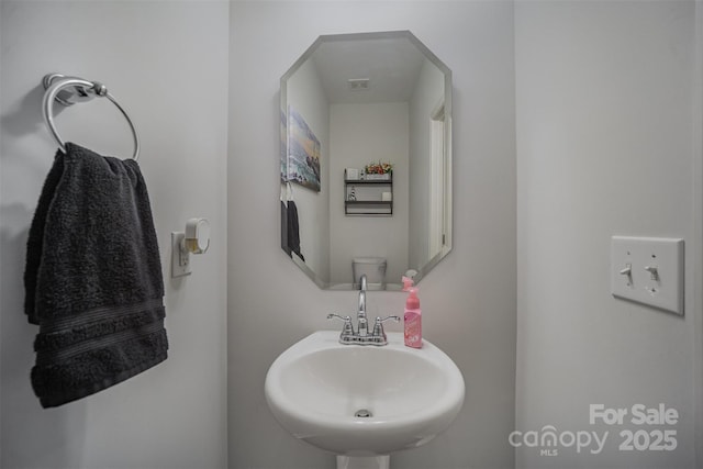 bathroom featuring sink and toilet