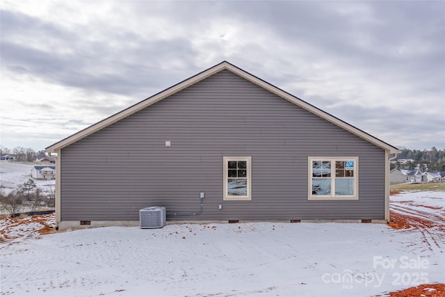 view of snowy exterior featuring cooling unit