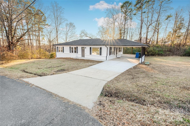 ranch-style home with a front lawn and a carport