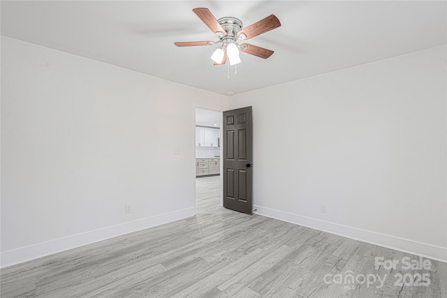 spare room with ceiling fan and light hardwood / wood-style floors