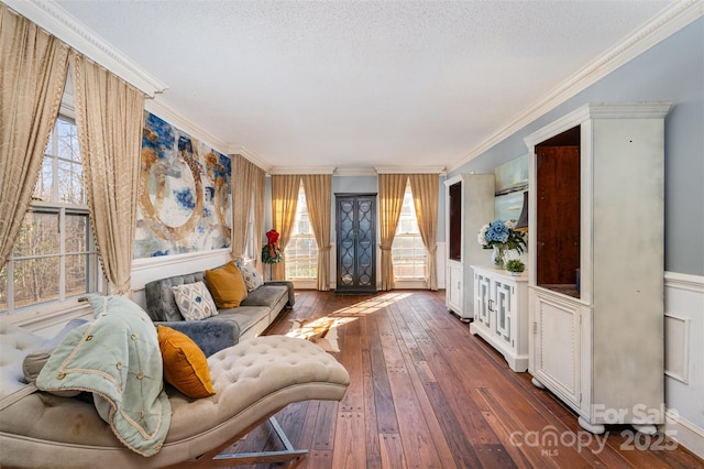 living room with a textured ceiling, dark wood-type flooring, plenty of natural light, and crown molding