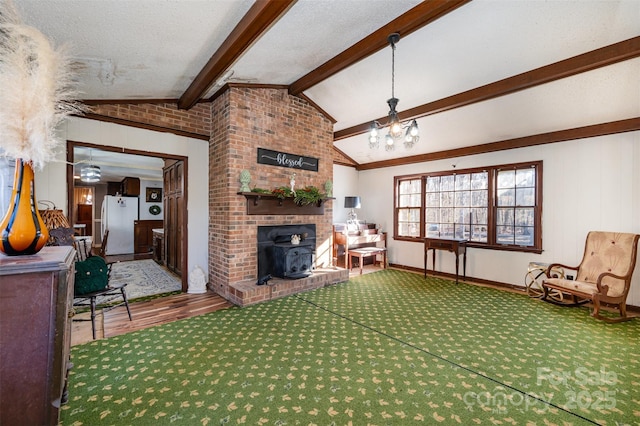 living room featuring a notable chandelier, vaulted ceiling with beams, a wood stove, and a textured ceiling