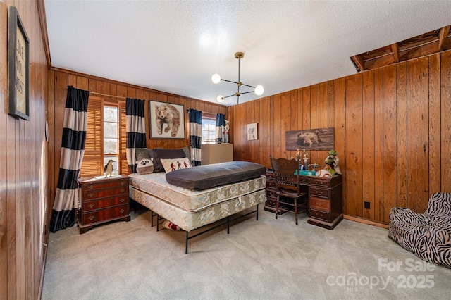 carpeted bedroom with a notable chandelier and wood walls