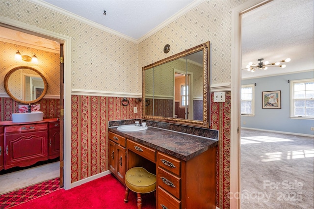 bathroom with a textured ceiling, vanity, and ornamental molding