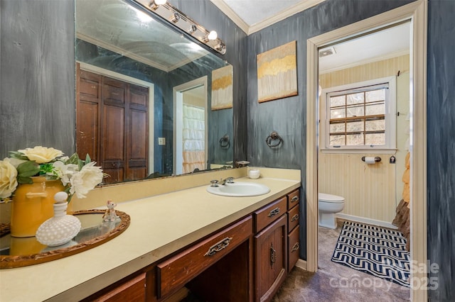 bathroom featuring vanity, toilet, and crown molding