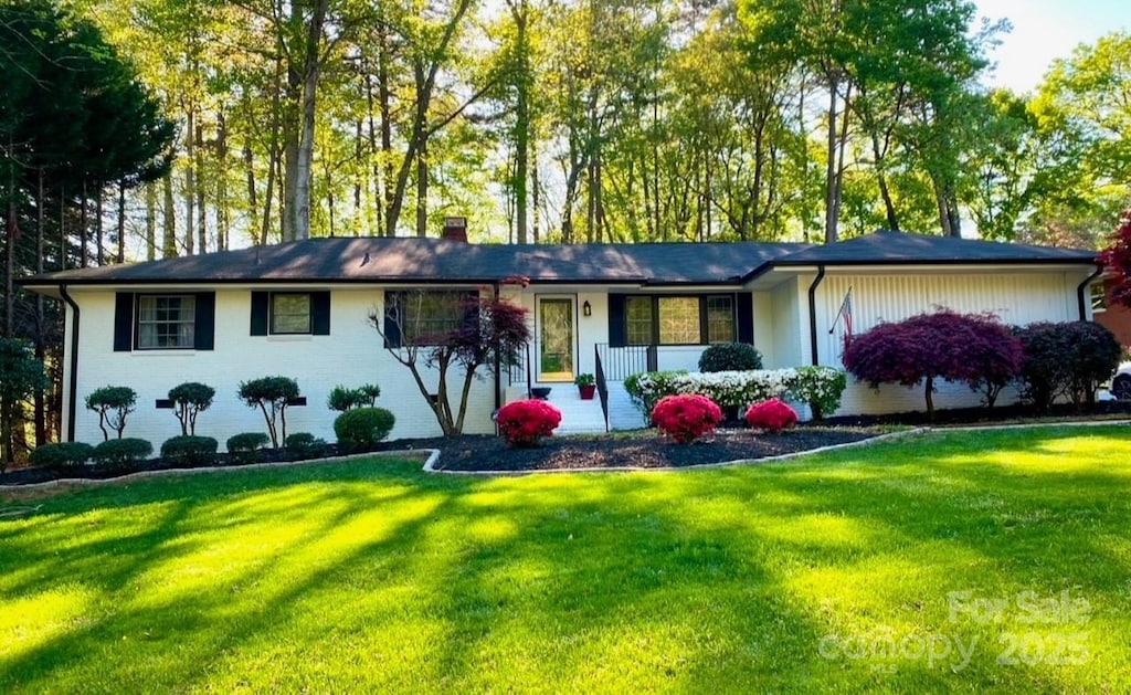 ranch-style house with a porch and a front lawn