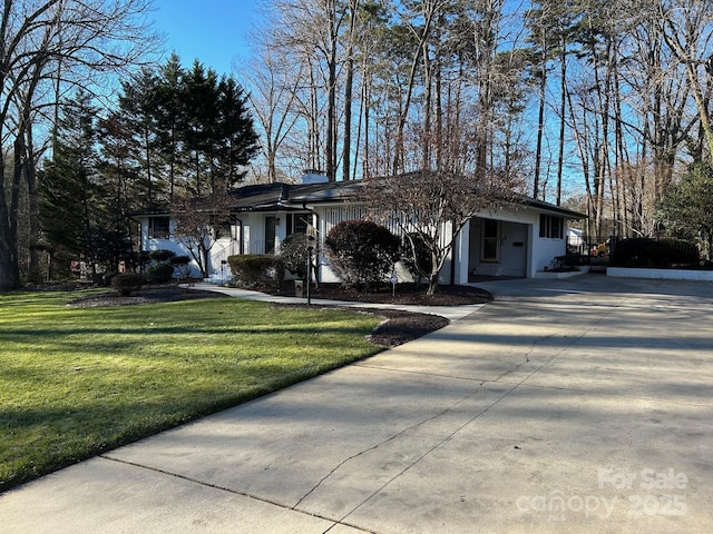 ranch-style home with a front lawn