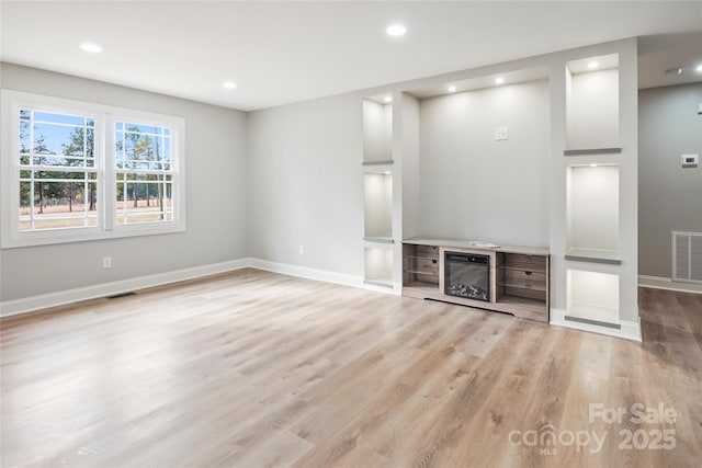 unfurnished living room featuring light wood-type flooring