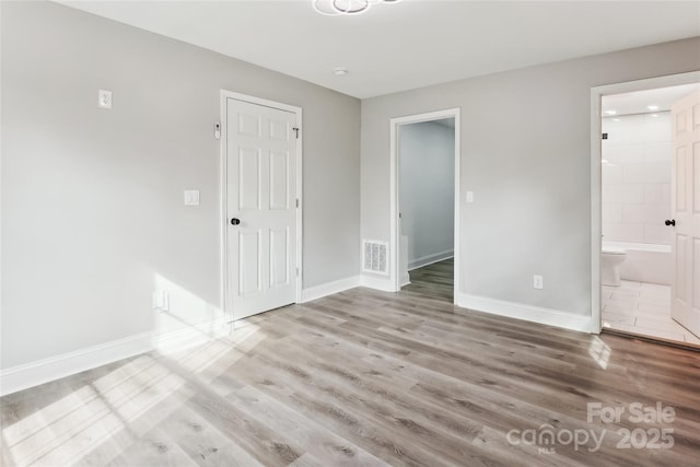 spare room featuring light wood-type flooring