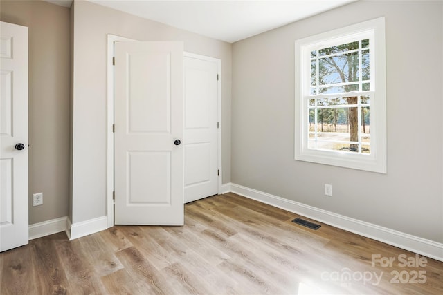 unfurnished bedroom with light wood-type flooring