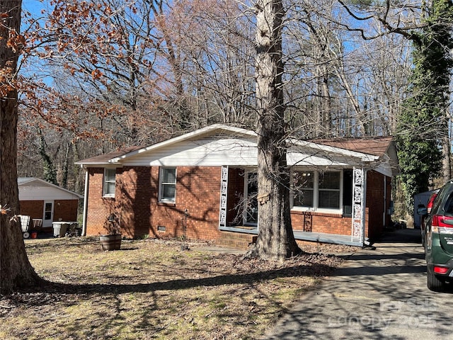 view of front facade featuring crawl space and brick siding