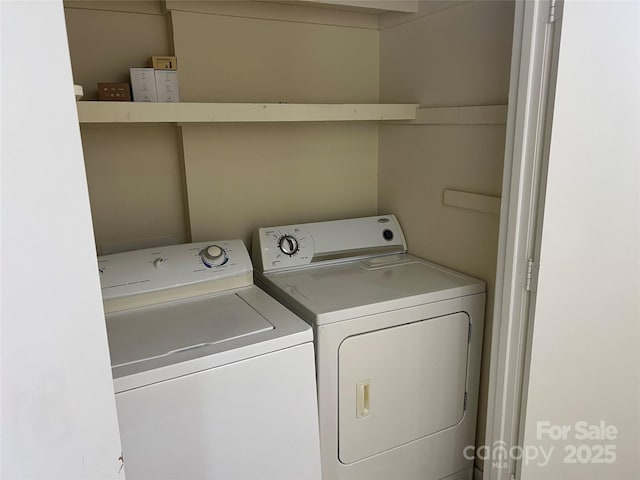 clothes washing area featuring washing machine and dryer and laundry area