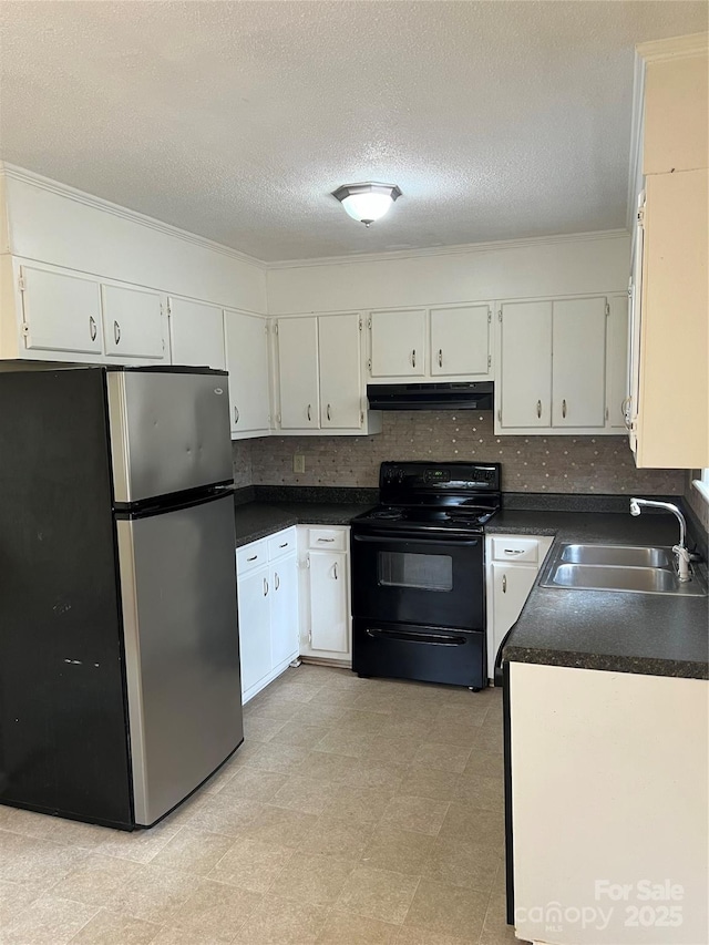 kitchen featuring dark countertops, black range with electric stovetop, under cabinet range hood, freestanding refrigerator, and a sink