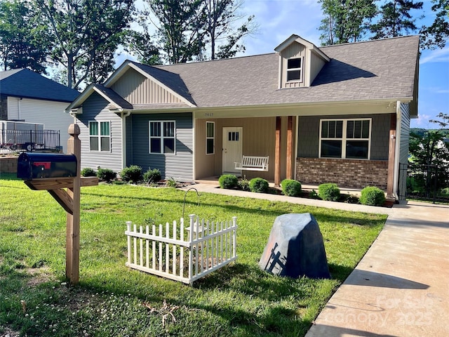 view of front facade with a front lawn and a porch