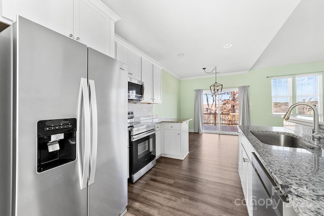 kitchen with light stone countertops, white cabinets, appliances with stainless steel finishes, sink, and dark hardwood / wood-style floors