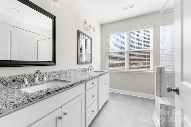 bathroom featuring a shower and vanity