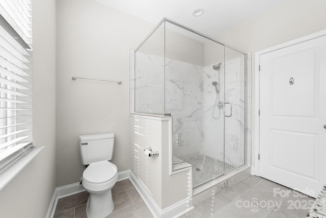 bathroom with a wealth of natural light, toilet, walk in shower, and tile patterned flooring