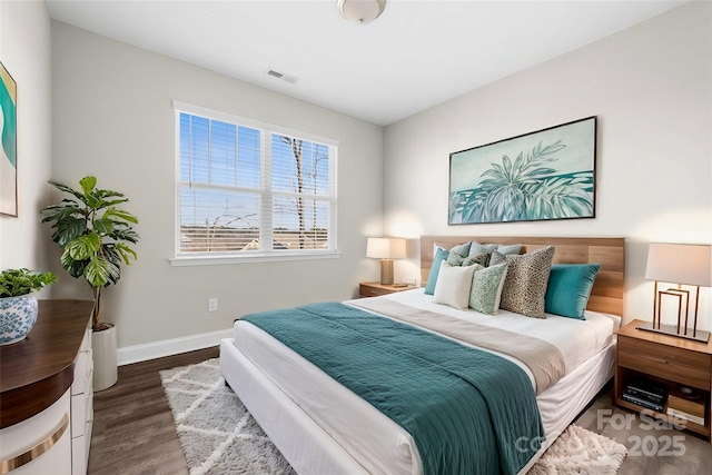 bedroom with dark wood-type flooring