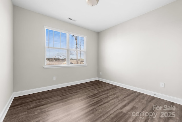 unfurnished room featuring dark hardwood / wood-style floors