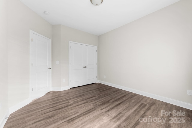 spare room with dark wood-type flooring