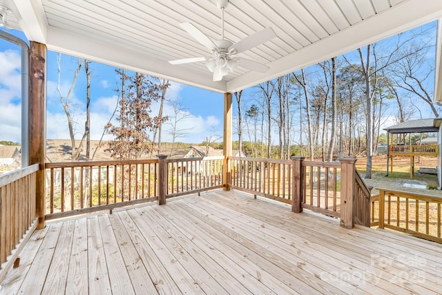 wooden terrace featuring ceiling fan