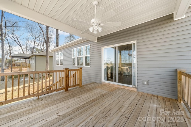 wooden deck featuring ceiling fan