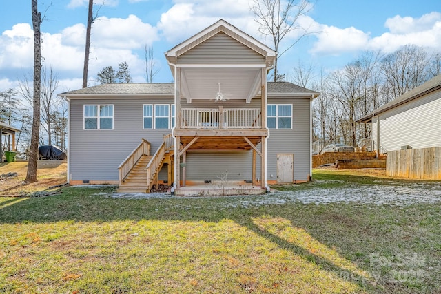 rear view of property with ceiling fan, a deck, a yard, and a patio area