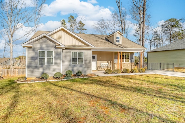 view of front of house featuring covered porch and a front lawn