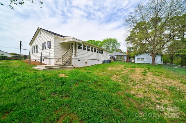 back of property with a lawn