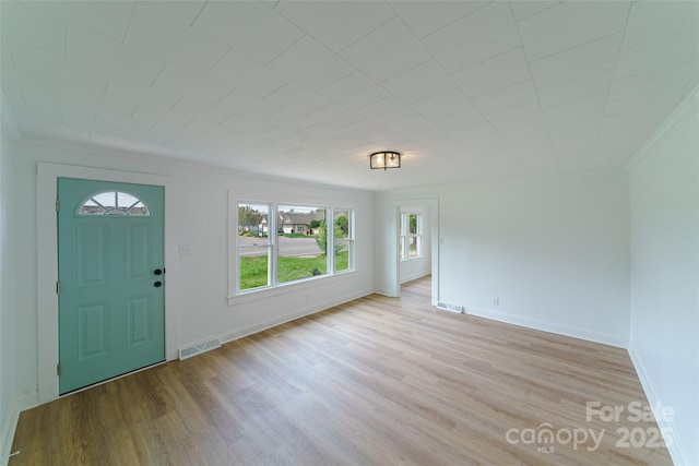 entryway featuring light hardwood / wood-style flooring and ornamental molding