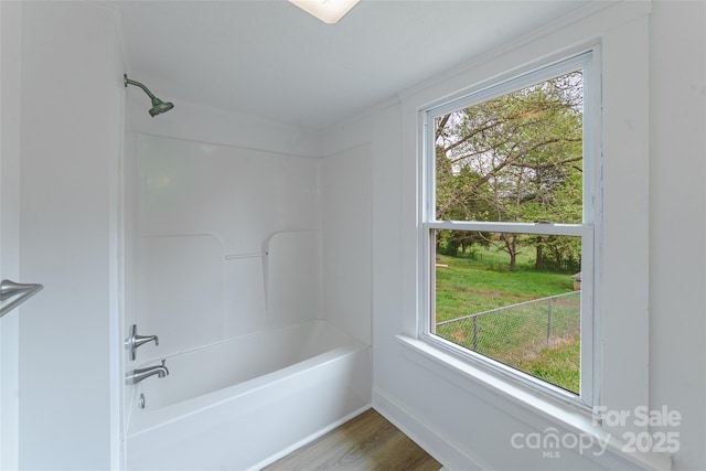 bathroom with wood-type flooring and shower / bathtub combination