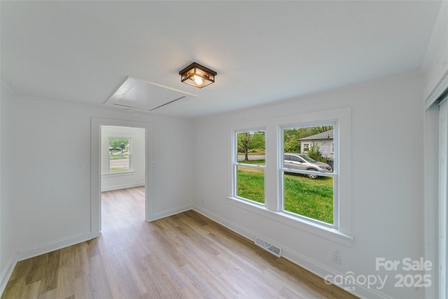 spare room with light hardwood / wood-style flooring