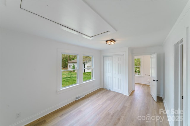 unfurnished bedroom featuring a closet and light wood-type flooring