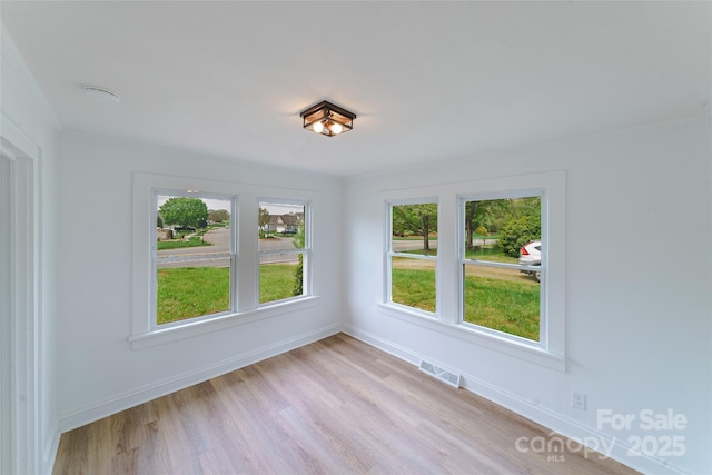 unfurnished room with light hardwood / wood-style flooring