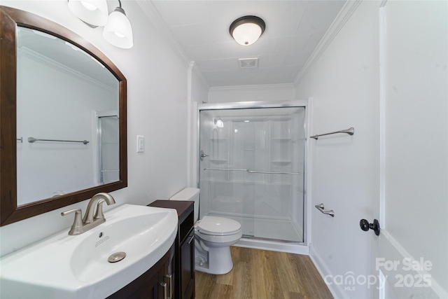 bathroom with walk in shower, crown molding, toilet, vanity, and hardwood / wood-style flooring