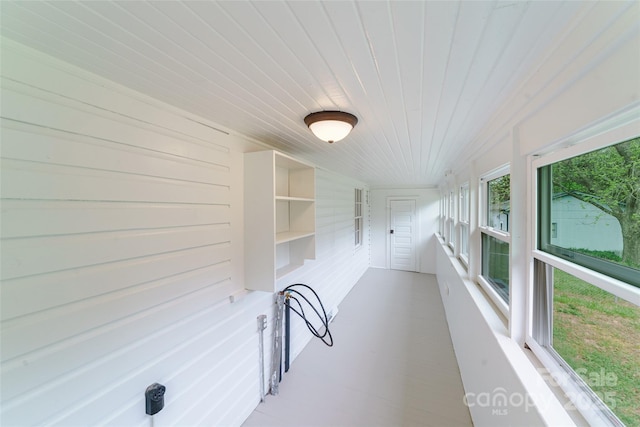 unfurnished sunroom with wood ceiling