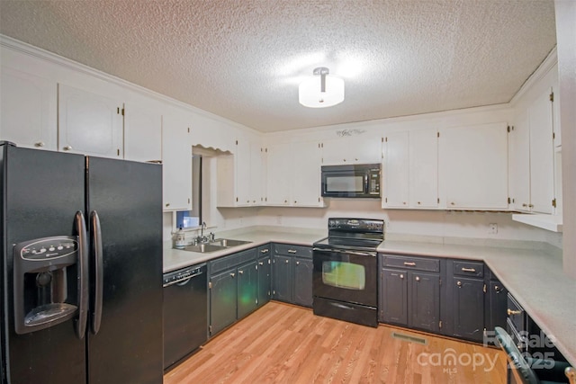 kitchen with white cabinets, sink, and black appliances