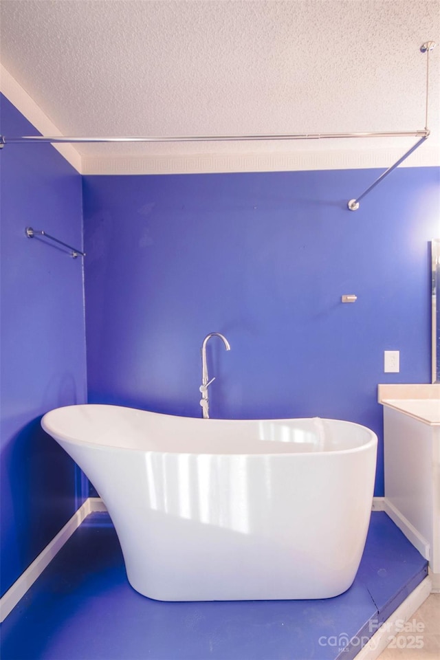 bathroom featuring a bathtub, a textured ceiling, and concrete floors