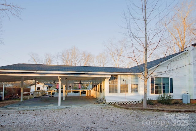 back of house with a carport