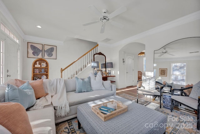 living room featuring hardwood / wood-style floors, ceiling fan, and ornamental molding