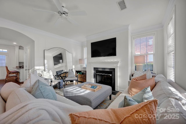 living room with ceiling fan, hardwood / wood-style flooring, and ornamental molding