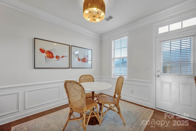 dining area featuring hardwood / wood-style floors and ornamental molding