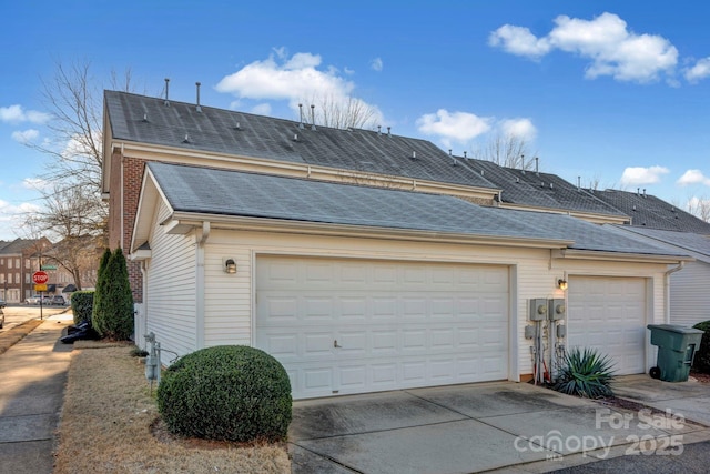 view of side of property with a garage